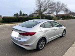 2018 Hyundai Elantra SEL in silver exterior parked on the street, showcasing its sleek design and excellent condition.