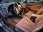 Interior view of a 2012 Nissan Altima, showing dashboard and seats, ideal for first-time car buyers.