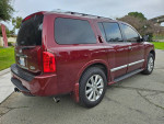 2010 INFINITI QX56 SUV in maroon color, showcasing its clean exterior and third-row seating feature.