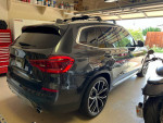 2019 BMW X3 in garage, showing sleek design and M wheel package, well-maintained with panoramic roof.