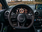 Interior view of a 2018 Audi RS3, highlighting the steering wheel and dashboard features.