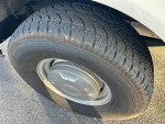 Close-up of the tire on a 1991 Ford F250 Super Duty truck, showcasing tread and wear.