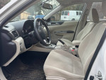 Interior view of a 2011 Subaru Impreza showing heated seats and steering wheel.