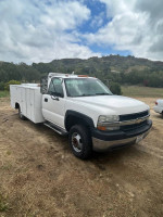 2001 Chevrolet Silverado 3500 service truck with storage and towing capabilities, salvage title, 120,000 miles.