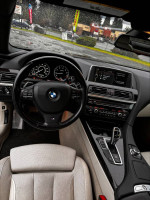 Interior view of a 2012 BMW 650i gran coupe showing the steering wheel and controls.