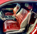Interior view of a 2014 Dodge Challenger SXT, featuring leather seats and modern dashboard design.