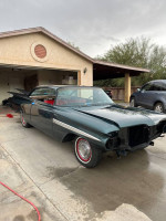 1959 Chevrolet Impala with a new paint job and chrome bumpers parked in a driveway.