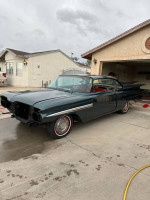 1959 Chevrolet Impala with a new paint job and interior, parked in a residential driveway.