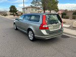 2008 Volvo V70 3.2 FWD wagon parked on the street, featuring a silver exterior and black leather interior.