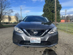 Front view of a 2017 Nissan Sentra, clean title, 126k miles, excellent condition, gray color parked outdoors.