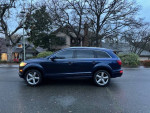 Side view of a 2008 Audi Q7 in blue color parked outdoors, showcasing its clean design and alloy wheels.