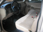 Interior view of a well-maintained F150 XL with low mileage, featuring clean seats and dashboard.