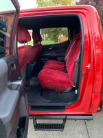 Interior view of a red 2019 Toyota Tacoma TRD Off Road showing spacious rear seating and step side.