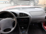 Interior view of a 1998 Chevrolet Metro showcasing the dashboard and controls.