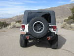 Rear view of a 2007 Jeep Wrangler with 92,000 miles, showcasing off-road features and rugged tires.