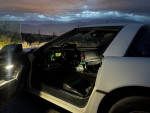 Interior view of a 1987 Chevrolet Corvette with ambient lighting and modern features at dusk