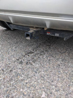 Hitch installed on a 2013 Honda Fit parked on the gravel, showcasing its towing capability and cargo area.