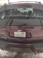 Rear view of a maroon 2006 Chevrolet TrailBlazer with visible license plate and spacious interior.