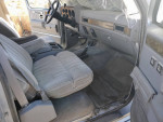 Interior view of a 1991 Chevrolet Suburban 1500 with beige upholstery and vintage design features.
