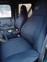 Interior view of a 1999 Jeep Wrangler featuring upgraded seats and interior accessories.