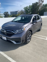 2021 Honda CR-V EX in showroom condition, grey exterior, parked in a sunny lot with ample features and low mileage.