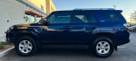 2014 Toyota 4Runner SR5 RWD, blue SUV parked outside with low mileage of 104,000 miles.