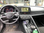 Interior view of a 2022 Hyundai Elantra with modern dashboard and controls, showcasing tech features and clean design.