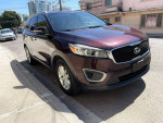 2016 Kia Sorento L FWD in purple parked on the street with a modern city backdrop.