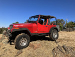 1994 Jeep Wrangler equipped for off-roading, featuring lifted suspension and BF Goodrich tires.