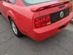 2007 Ford Mustang in red, showing rear design and cosmetic details, includes winter tires.