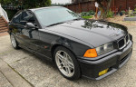 1995 BMW M3 Dinan Supercharged in excellent condition with 70,000 miles, showcasing a sleek black exterior.