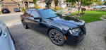 2016 Chrysler 300S in black with alloy wheels parked in a residential area