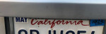 Close-up of the rear license plate of a 2013 Volkswagen Tiguan S, showcasing California registration and details.