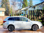 Silver 2018 Mitsubishi Outlander GT AWD parked in a clean setting with modern architecture in the background
