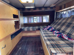 Interior of a 1989 Dodge Ram 4X4 turbo diesel truck featuring plaid upholstery and wooden panels.
