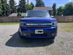 Front view of a blue 2014 Ford Flex SEL, spacious for 7 passengers, parked outdoors