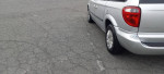2006 Chrysler Town and Country silver van parked with good condition tires and slight scratches on the body