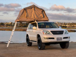 2008 Lexus GX 470 4WD in pearl white with a rooftop tent, ideal for off-road adventures and camping.