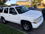 2005 Chevrolet Tahoe Z71 4WD with new tires parked on residential street, clean title and sunroof.