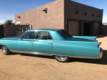 1963 Cadillac Fleetwood in mint condition with classic turquoise color and chrome detailing.