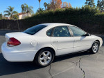 2004 Ford Taurus SES FWD in white with 103,000 miles parked outdoors, showcasing its clean exterior and design.
