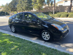 2008 Toyota Prius parked on the street, showcasing its sleek design and hybrid features.