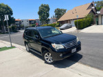 2010 Lexus GX 460 4WD parked on street with clean exterior, ready for sale with 122,000 miles and tow hitch.