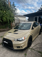 2011 Mitsubishi Evo X GSR in beige, featuring upgrades like a Precision turbo and ETS exhaust.