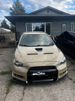 2011 Mitsubishi Evo X GSR in beige color with upgrades, front view in residential area