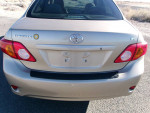 Rear view of a 2009 Toyota Corolla LE in good condition with low mileage, showing taillights and trunk area.