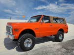 1971 Chevrolet K5 Blazer LS swap with modern upgrades, parked on sandy terrain under a blue sky.