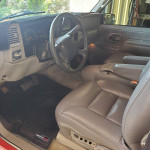 Interior view of a 1999 Chevrolet Tahoe SUV showcasing leather seats and dashboard features.