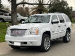 2007 GMC Yukon Denali AWD, white exterior, chrome wheels, parked in a driveway, well-maintained family vehicle