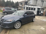 2009 Mazdaspeed 3 in excellent condition, showcasing custom wheels and modifications, parked on a driveway.